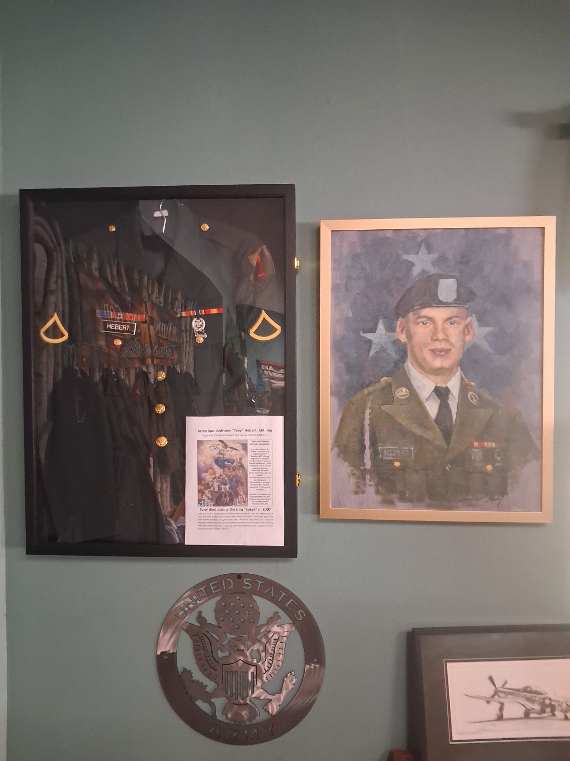 Museum memorial display with Tony Hebert’s uniform and portrait
