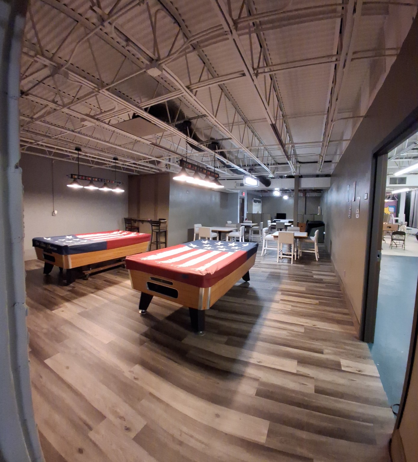 Wild Loon Saloon pool room with two American flag pool tables and seating